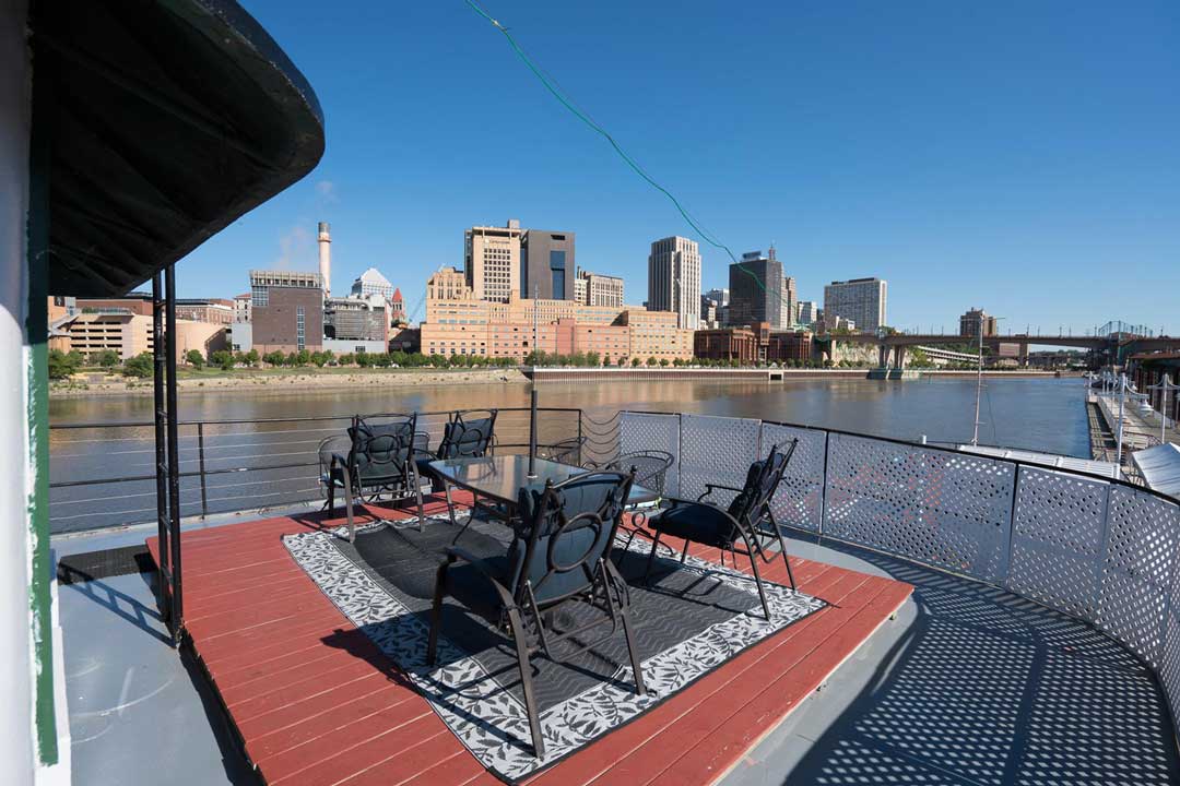 Covington Inn Deck furnished with a table and chairs.