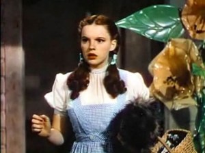 Screenshot of a movie trailer with a woman dressed in a blue gingham dress